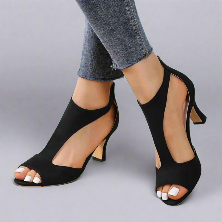 Heel sandal with curved cut